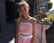 teen girl wearing french terry towelling halter neck crop top in pink and white